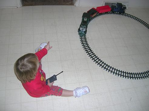 [Here I am playing with my train set that Santa brought me.]