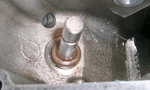 [Here you can see a nick in the vertical intake, valve guide seal.]