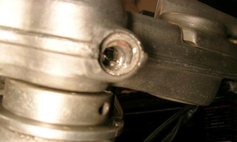 [The way the hole in the triple clamp looked before trying to remove the remains of the original bolt.]