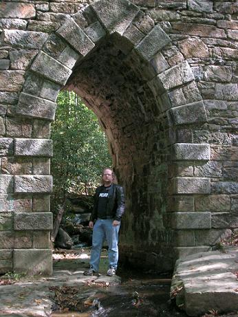[Here I am standing inside the archway of Poinsett Bridge.]