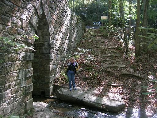[Vicki at the gothic archway of the bridge (with the Ducati looking down at us).]